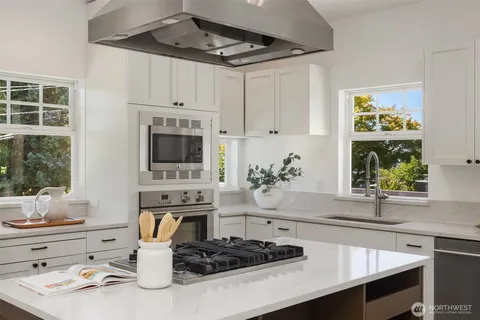 a kitchen with a stove a sink and a microwave