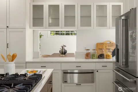 a kitchen with stainless steel appliances and cabinets