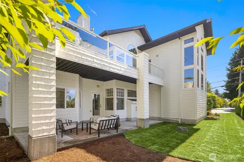 a view of a house with a patio and a yard