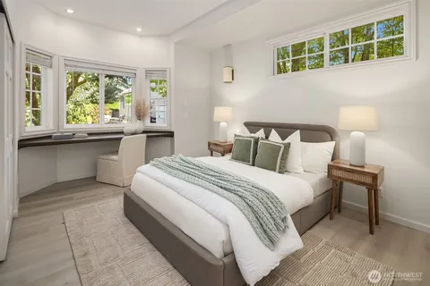 a bedroom with a large bed and a window