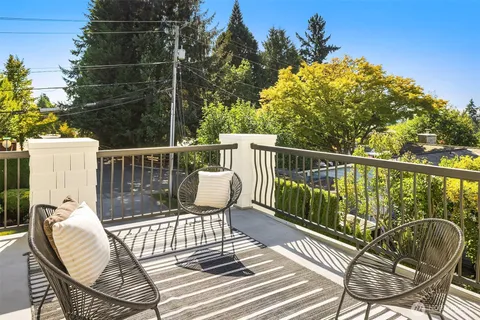 a view of balcony with wooden floor and outdoor seating