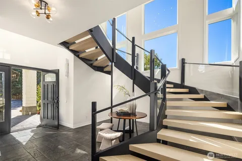 a view of entryway and hall with wooden floor