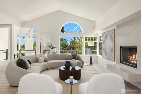 a living room with furniture fireplace and a large window