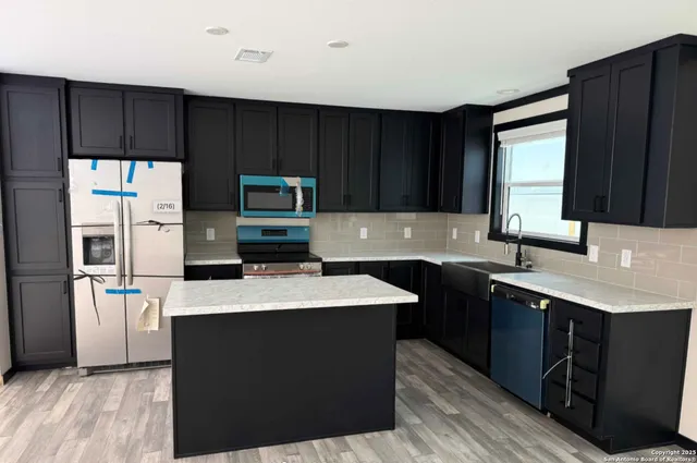 a kitchen with a sink a stove and refrigerator