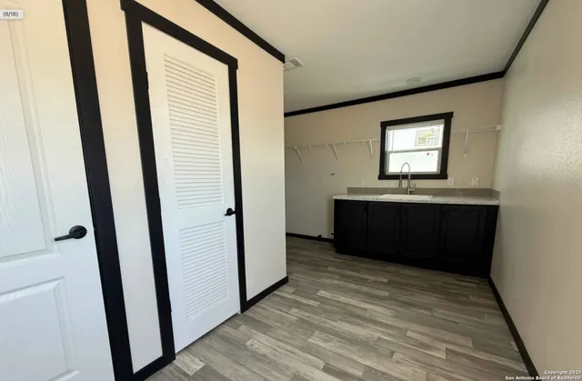 a room with window and hardwood floor