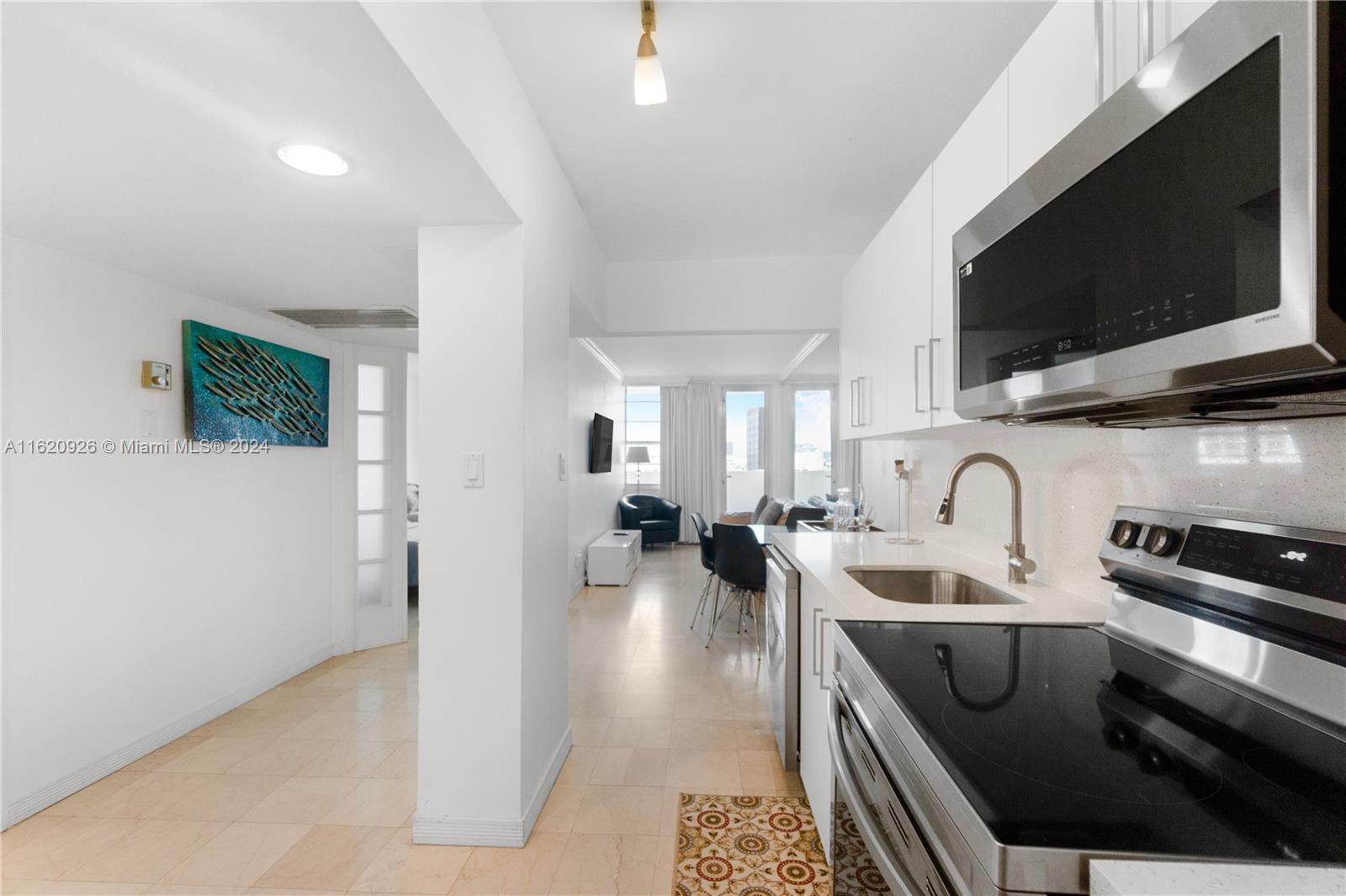 100 Lincoln Road, Unit 820 Miami Beach, FL 33139 - Photo 4 of 20 a living room with furniture and a flat screen tv