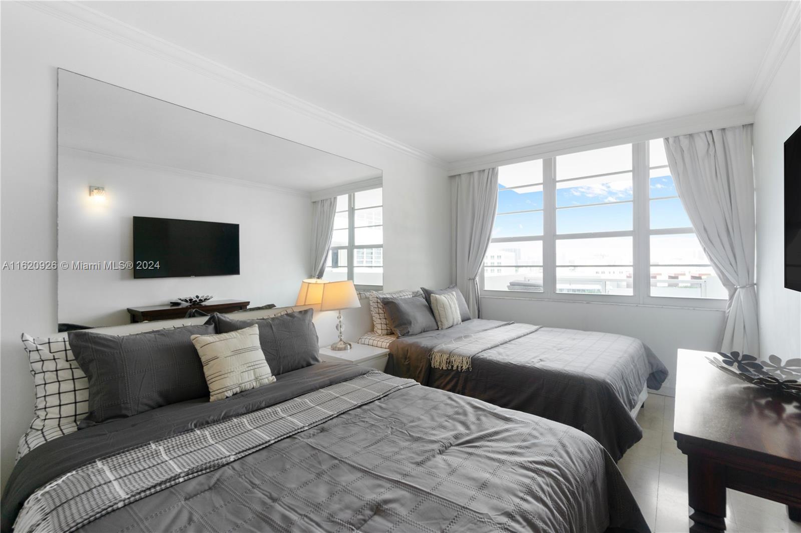 100 Lincoln Road, Unit 820 Miami Beach, FL 33139 - Photo 5 of 20 a bedroom with two beds and a flat screen tv