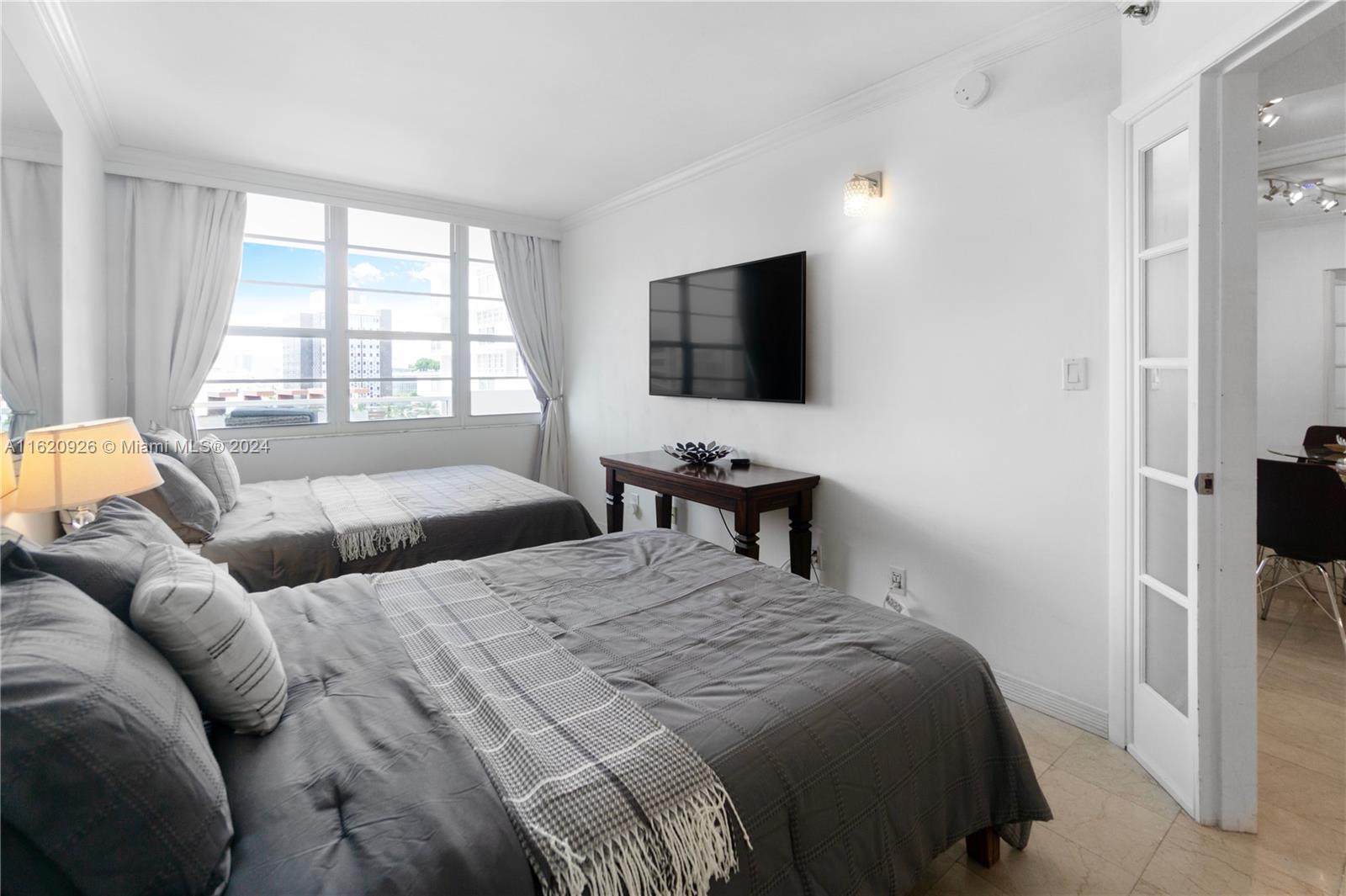 100 Lincoln Road, Unit 820 Miami Beach, FL 33139 - Photo 7 of 20 a bedroom with a bed and a flat screen tv