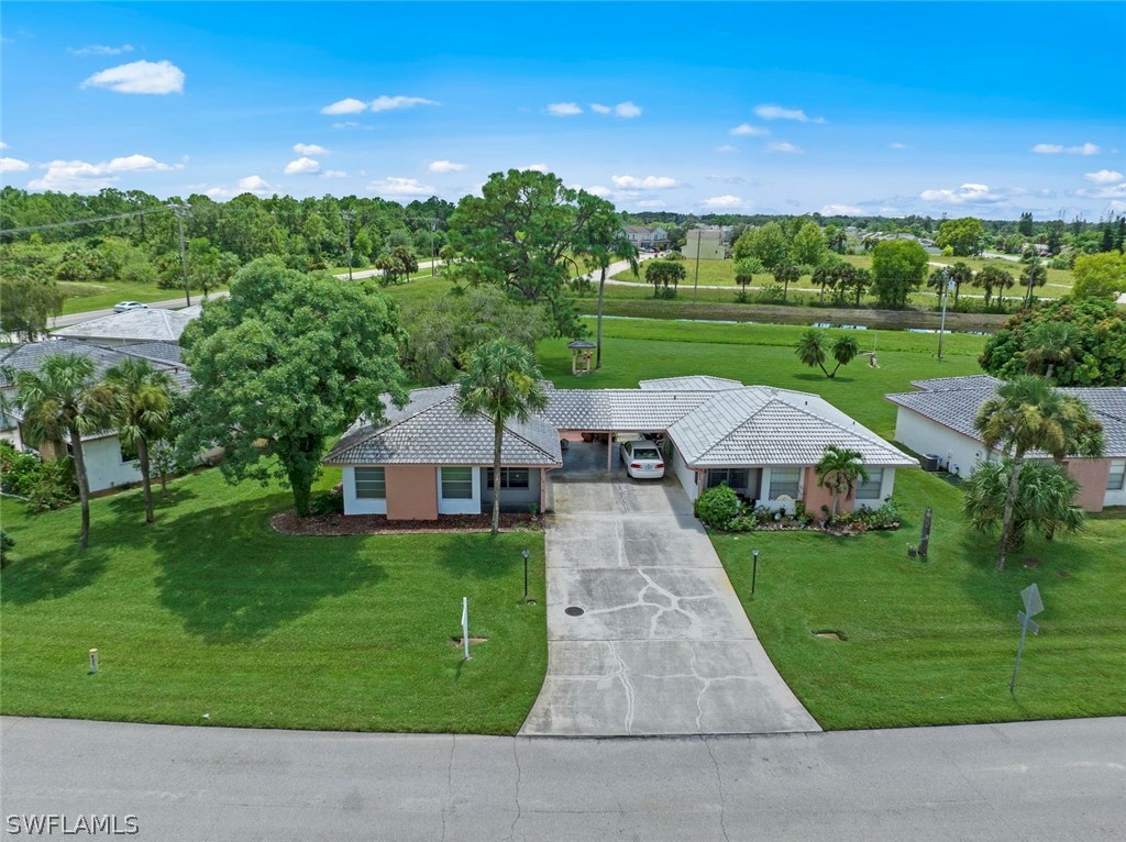 1604 Ridgecrest Street Lehigh Acres, FL 33936 - Photo 1 of 26 a aerial view of a house with a yard