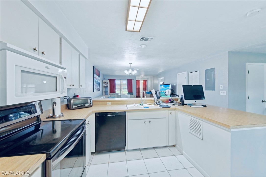 1604 Ridgecrest Street Lehigh Acres, FL 33936 - Photo 11 of 26 a kitchen with a sink stove and cabinets