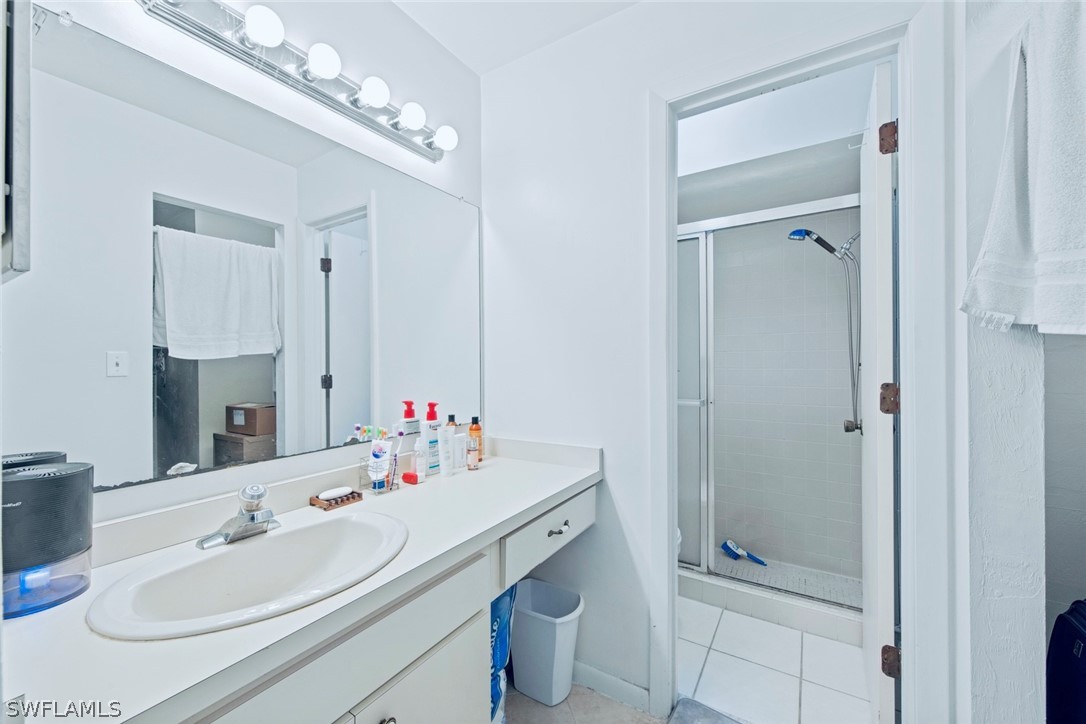 1604 Ridgecrest Street Lehigh Acres, FL 33936 - Photo 15 of 26 a bathroom with a sink double vanity and a mirror