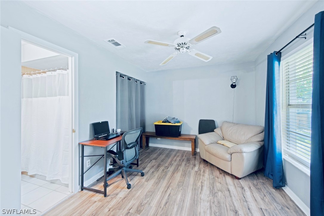 1604 Ridgecrest Street Lehigh Acres, FL 33936 - Photo 17 of 26 a living room with furniture and wooden floor