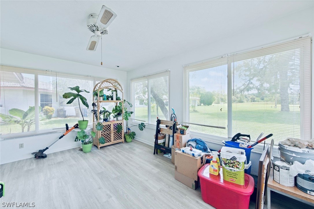 1604 Ridgecrest Street Lehigh Acres, FL 33936 - Photo 21 of 26 a living room with furniture and a floor to ceiling window