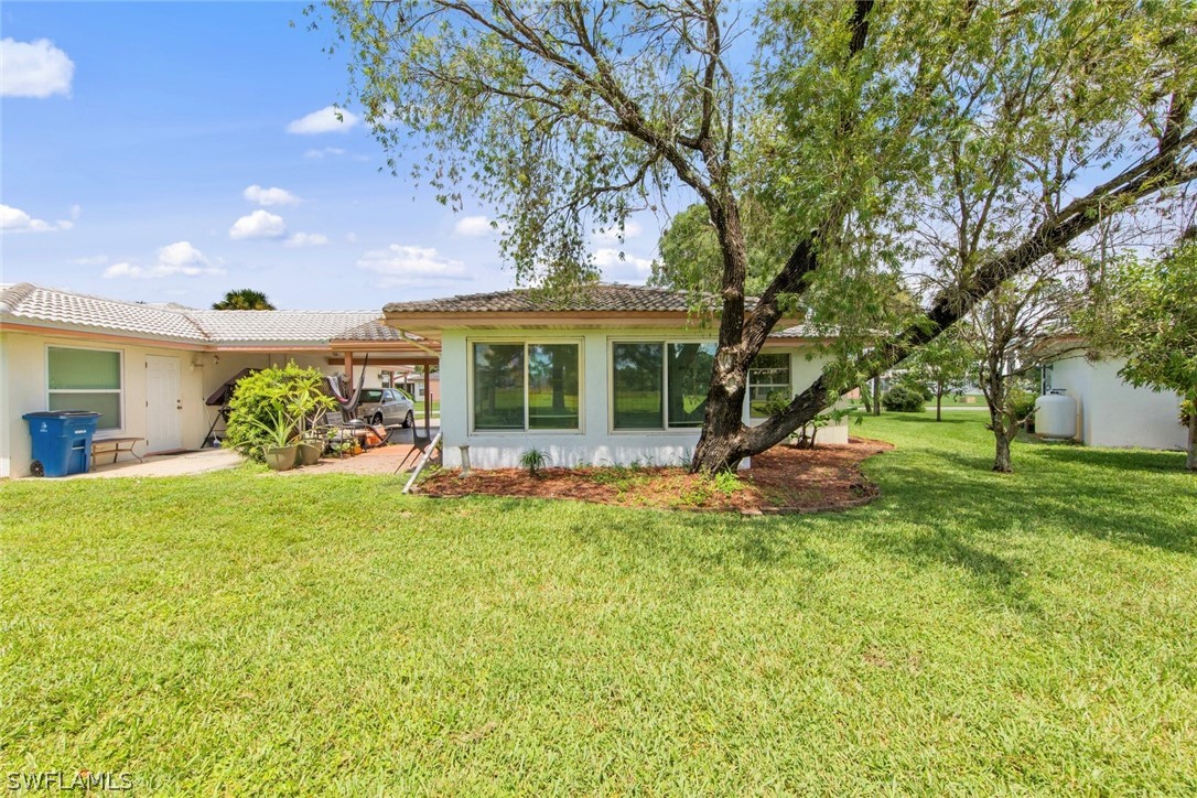 1604 Ridgecrest Street Lehigh Acres, FL 33936 - Photo 24 of 26 a view of a house with a backyard