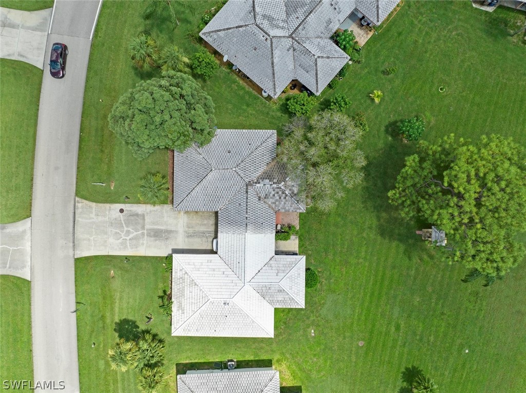 1604 Ridgecrest Street Lehigh Acres, FL 33936 - Photo 25 of 26 an aerial view of a house with a garden