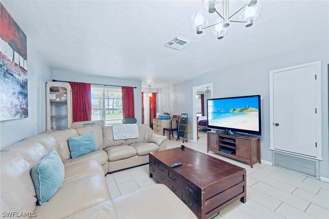 1604 Ridgecrest Street Lehigh Acres, FL 33936 - Photo 6 of 26 a living room with furniture and a flat screen tv