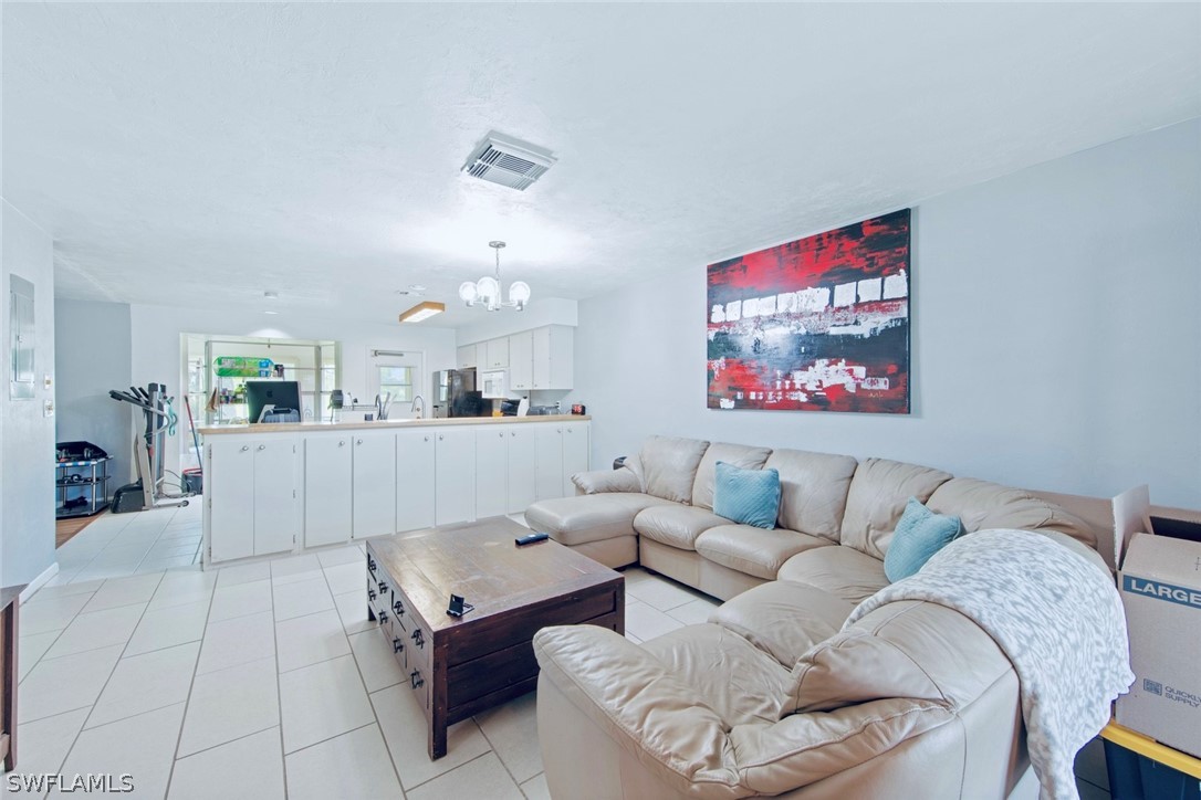 1604 Ridgecrest Street Lehigh Acres, FL 33936 - Photo 7 of 26 a living room with furniture and a flat screen tv