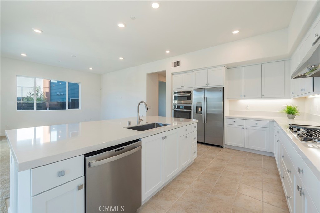 121 Baluster Irvine, CA 92618 - Photo 14 of 80 a kitchen with stainless steel appliances a sink stove and cabinets
