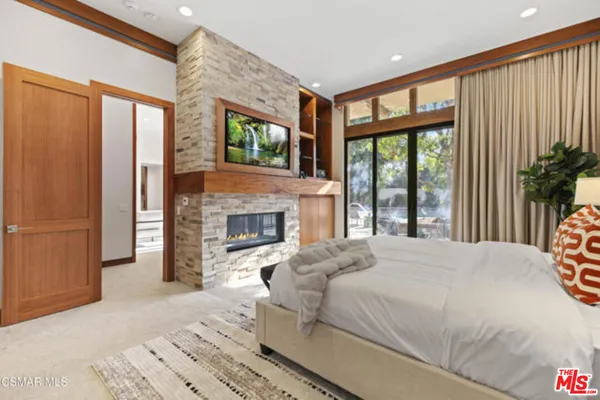 a bedroom with a bed and a fireplace