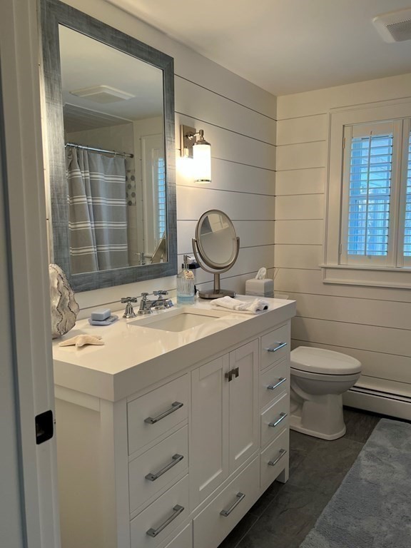 219 Training Field Road Chatham, MA 02633 - Photo 18 of 24 a bathroom with a granite countertop sink mirror and a toilet