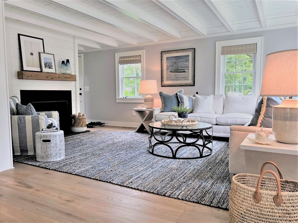 219 Training Field Road Chatham, MA 02633 - Photo 9 of 24 a living room with furniture and a fireplace