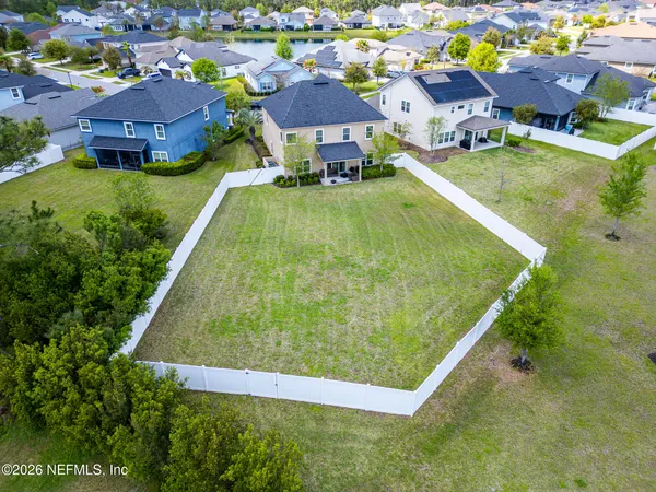 an aerial view of residential houses with outdoor space and swimming pool