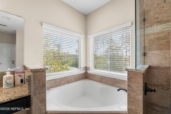 a bathroom with a sink vanity mirror and toilet