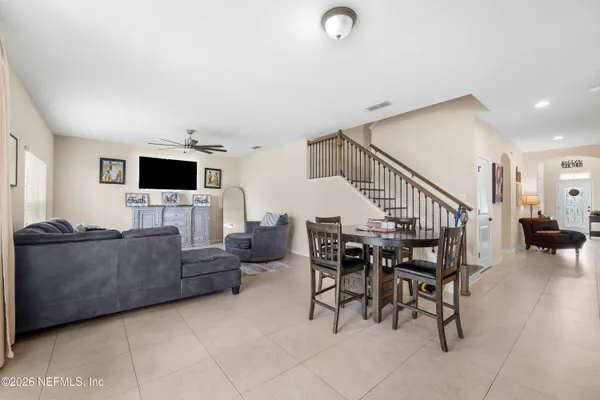 a kitchen with stainless steel appliances a sink a counter top space and living room view