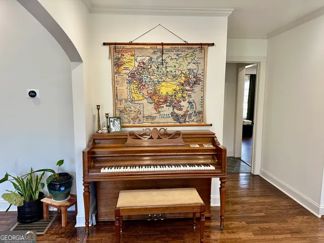 a bedroom with a bed a fireplace and a large window