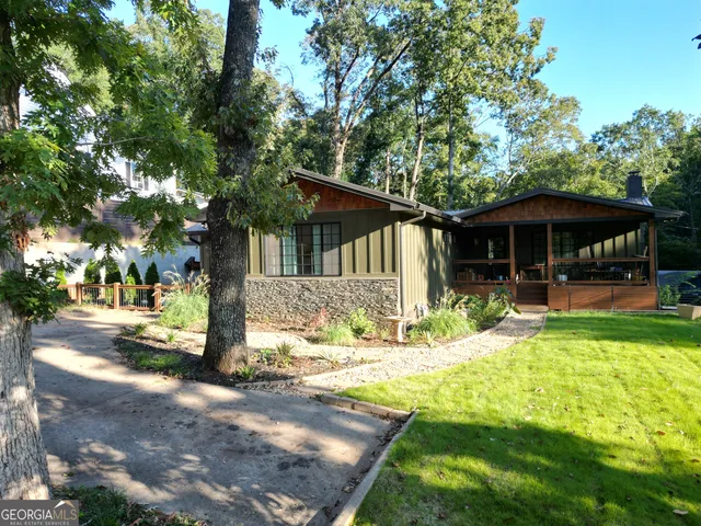 a view of a house with pool and sitting area