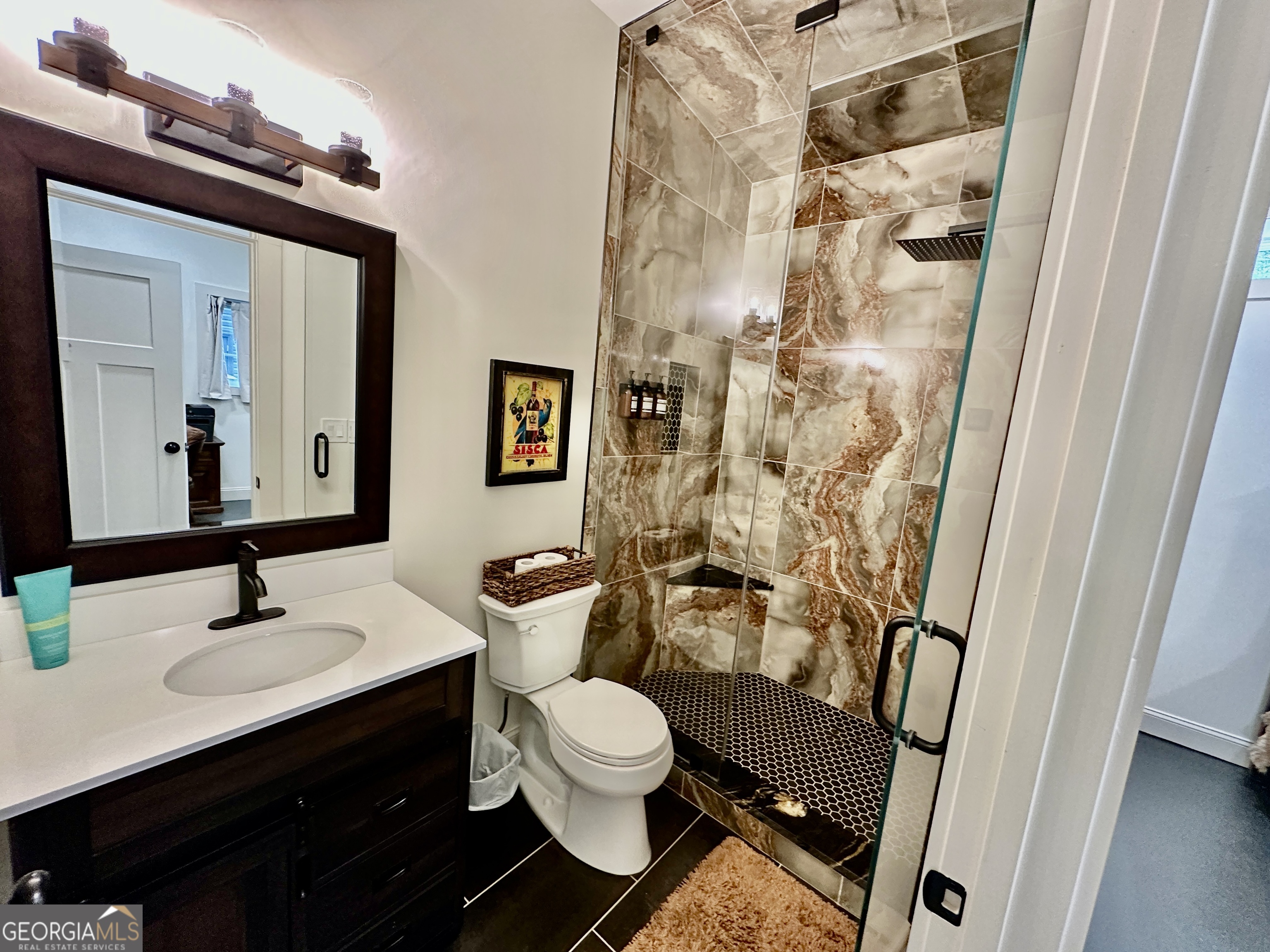 775 Ridgewood Avenue Gainesville, GA 30501 - Photo 32 of 77 a bathroom with a sink a toilet a mirror and shower