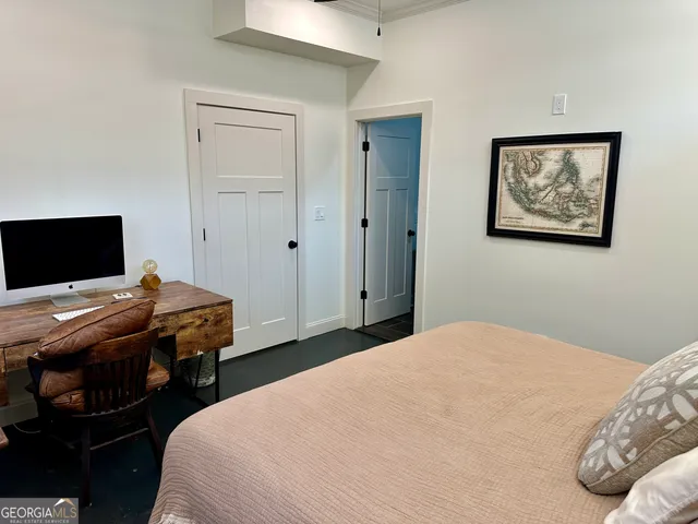 a living room with furniture a table and chairs next to a window