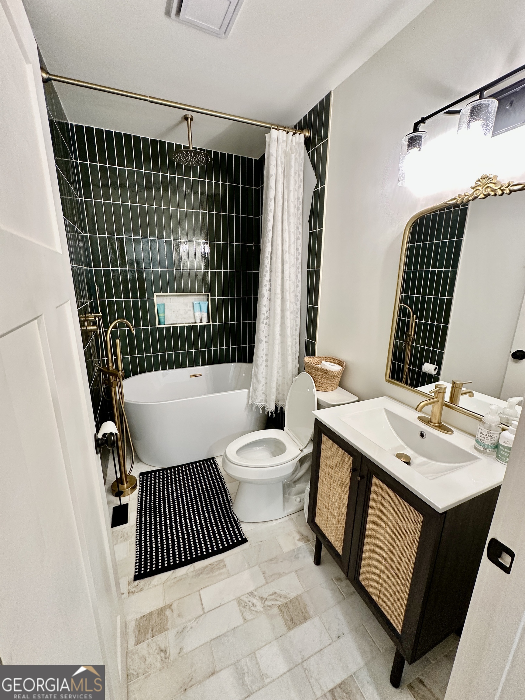 775 Ridgewood Avenue Gainesville, GA 30501 - Photo 39 of 77 a bathroom with a sink toilet a mirror and shower