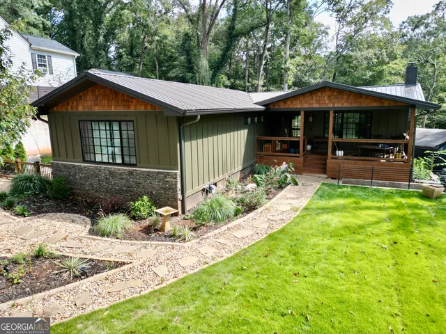 a view of a house with a yard and sitting area