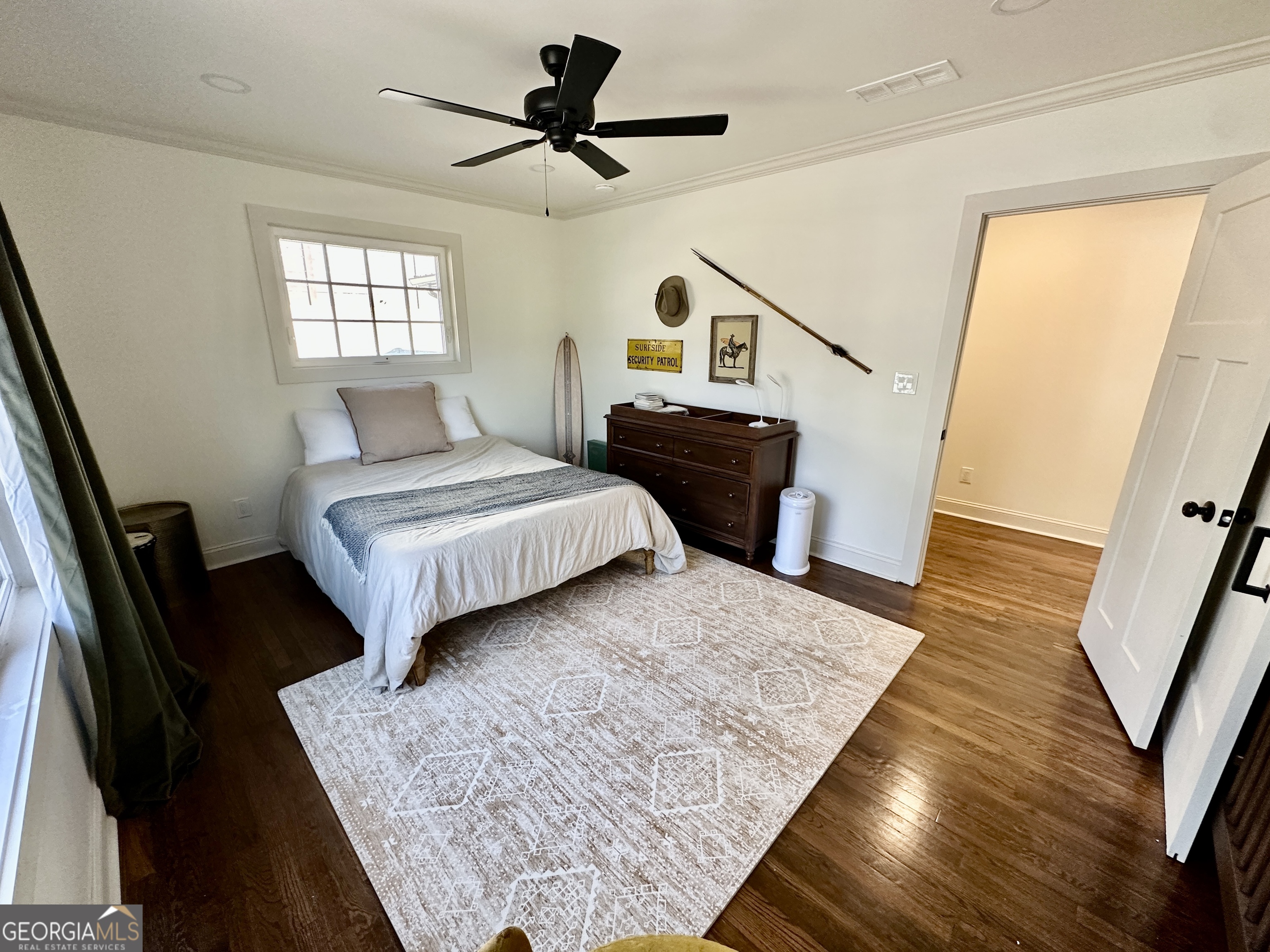 775 Ridgewood Avenue Gainesville, GA 30501 - Photo 42 of 77 a spacious bedroom with a bed a dresser and wooden floor