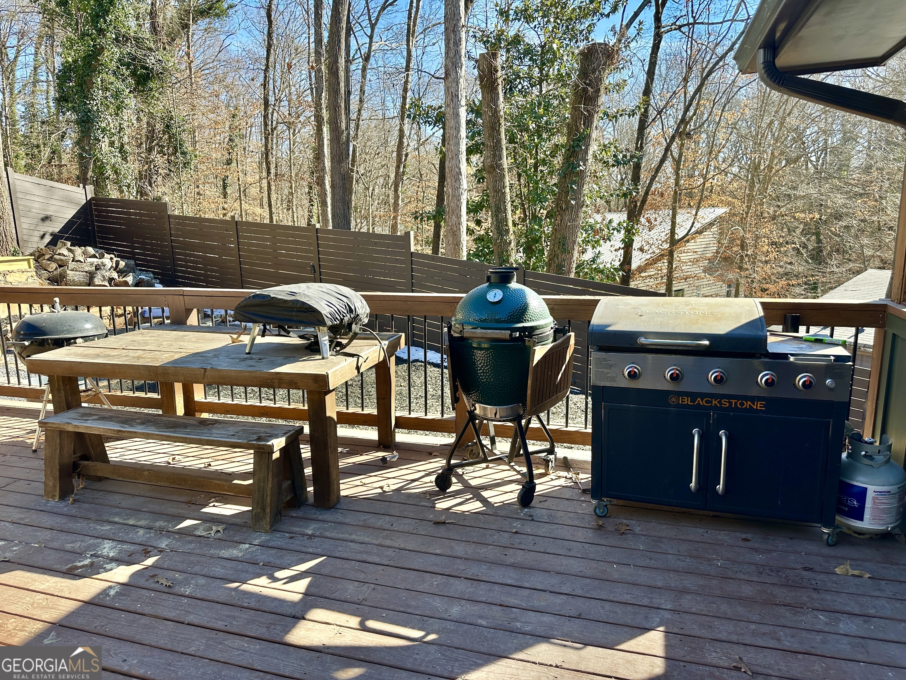 775 Ridgewood Avenue Gainesville, GA 30501 - Photo 55 of 77 a view of a patio with table and chairs with wooden floor and fence