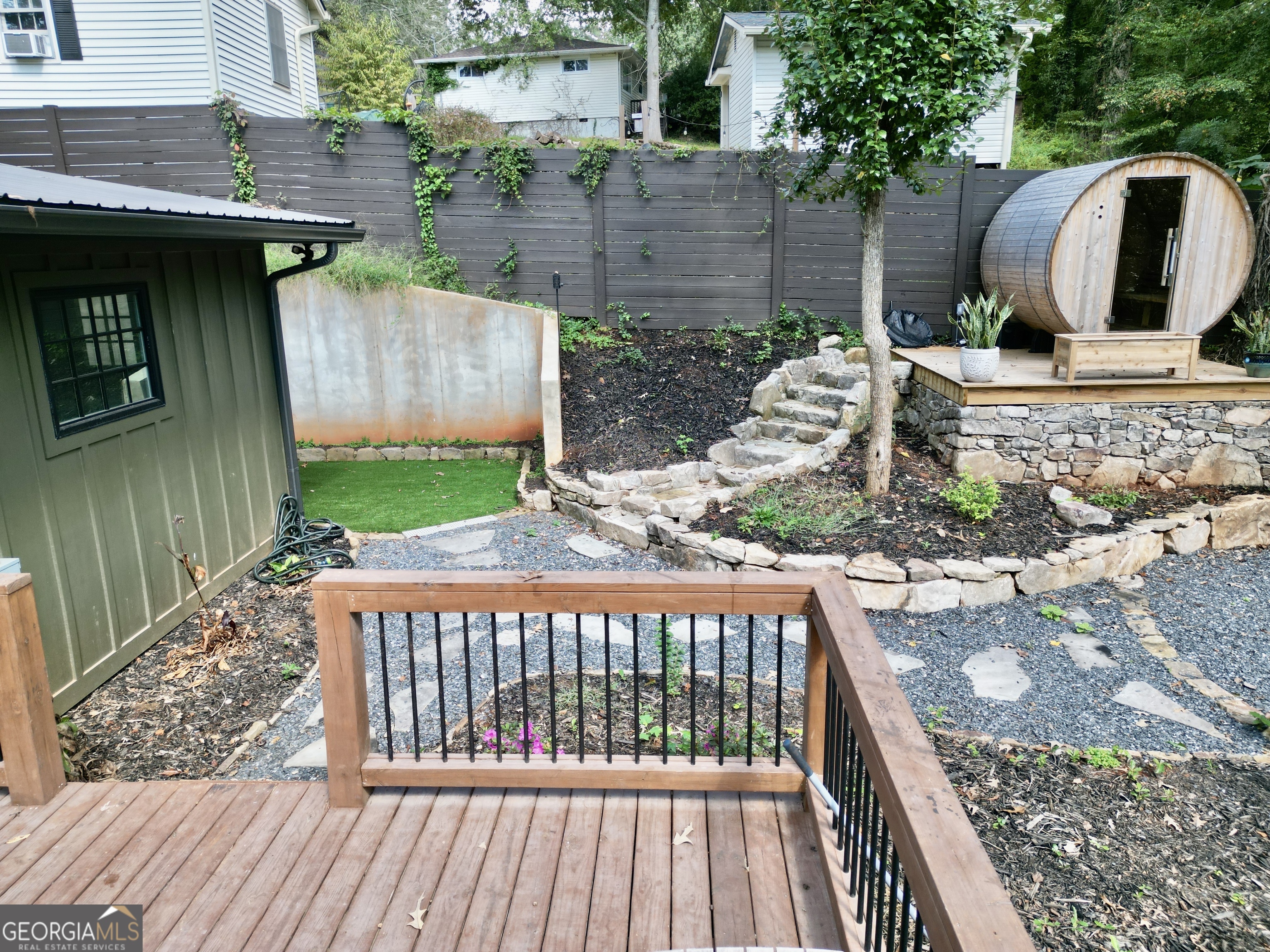 775 Ridgewood Avenue Gainesville, GA 30501 - Photo 62 of 77 a view of a wooden house with a bench in front of it
