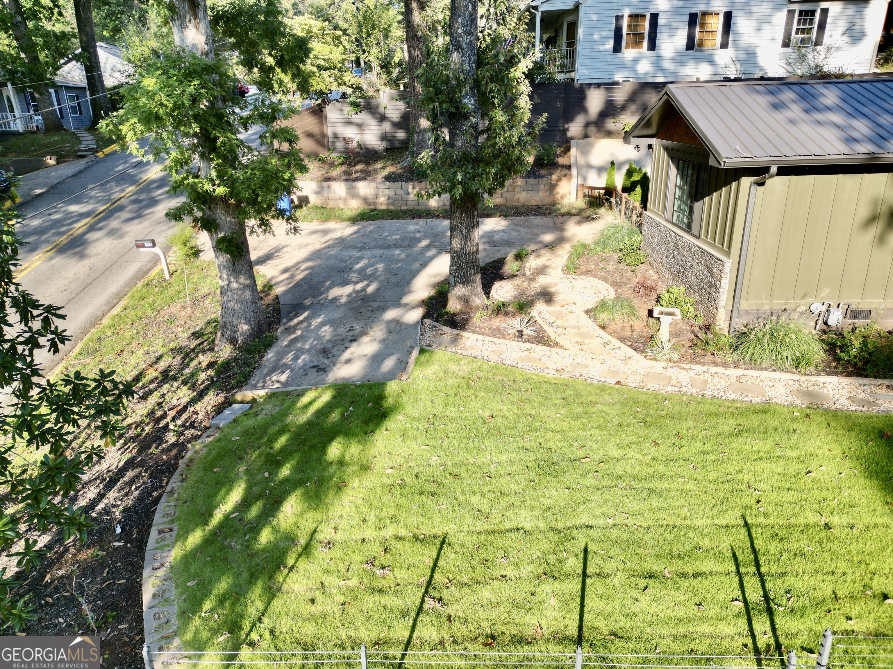 775 Ridgewood Avenue Gainesville, GA 30501 - Photo 65 of 77 a backyard of a house with large trees and plants