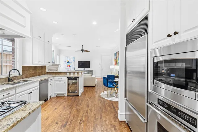 a kitchen with a sink stainless steel appliances and cabinets