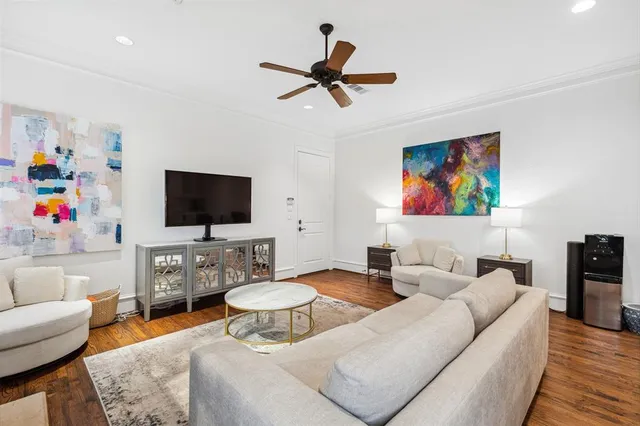 a living room with furniture kitchen view and a flat screen tv