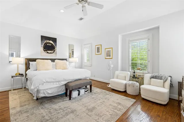 a spacious bedroom with a bed and a couch