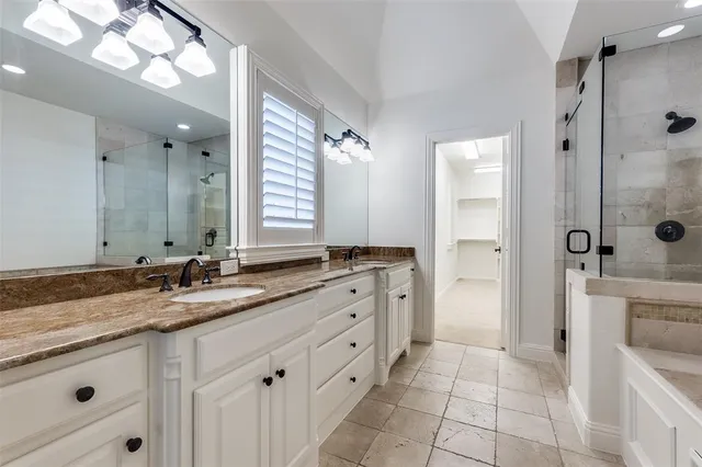 a bathroom with a granite countertop sink mirror and double