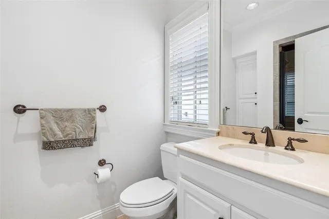 a bathroom with a sink toilet and a mirror