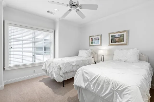 a bedroom with two beds and a window