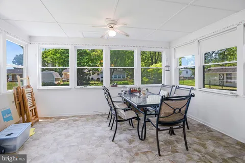 a view of a dining room with furniture large windows and wooden floor