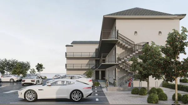 a front view of a residential apartment building with a yard
