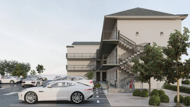 a front view of a residential apartment building with a yard