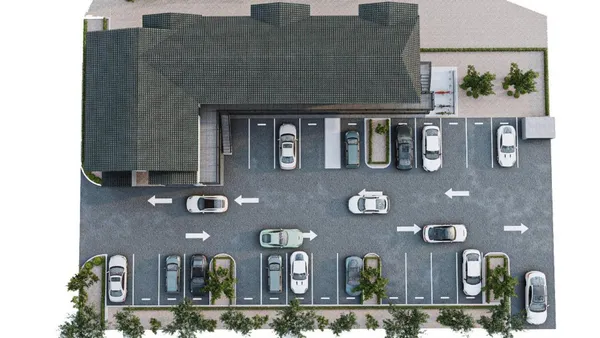 a front view of a building with retail shops and traffic signal