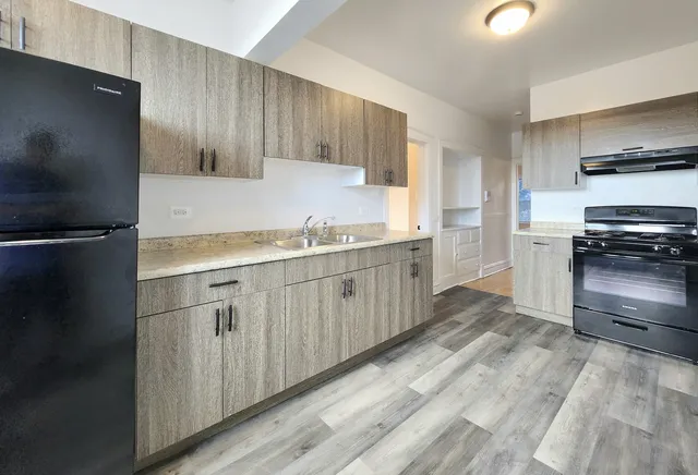 a kitchen with a sink stainless steel appliances and cabinets