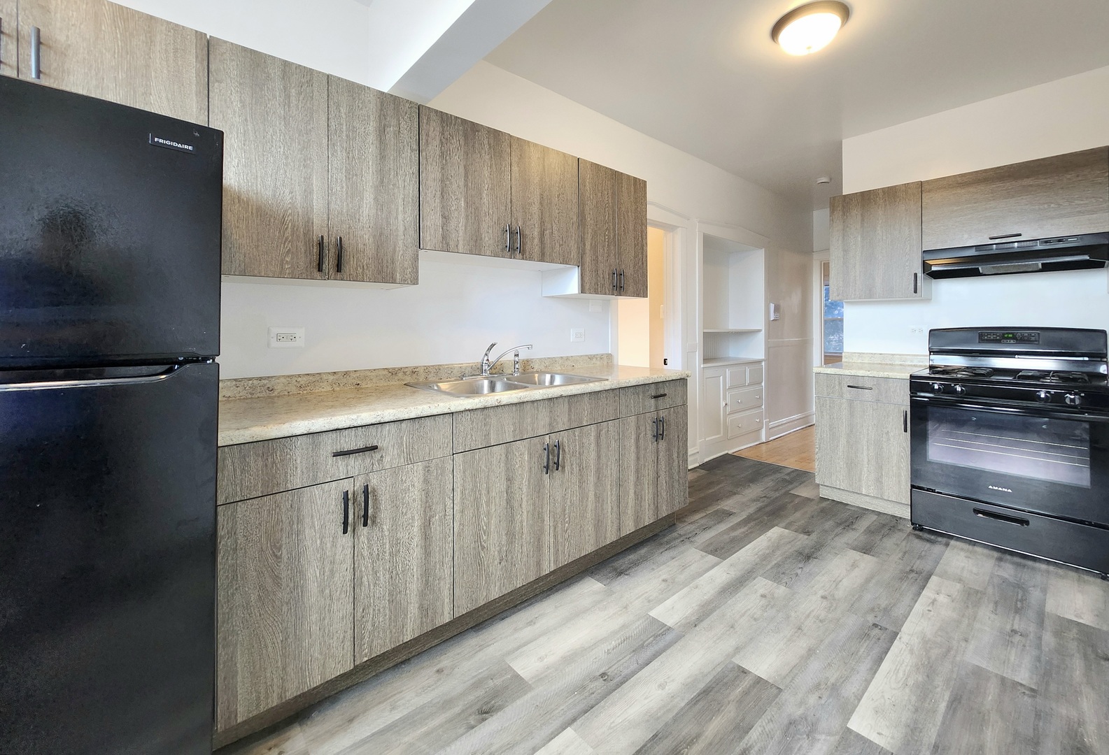 4937 West 18th Street, Unit 2W Cicero, IL 60804 - Photo 2 of 11 a kitchen with a sink stainless steel appliances and cabinets